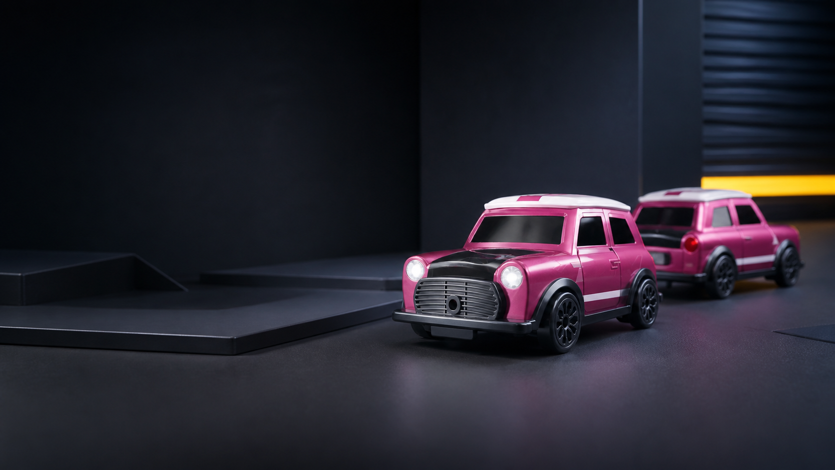Pink RC drift cars in a dark product studio